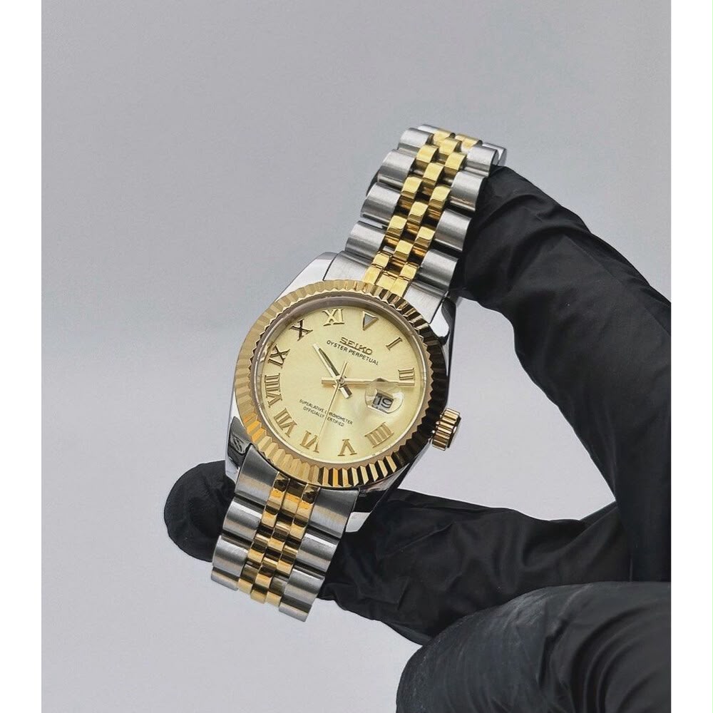 ORA Two-Tone Classic Date ladies Seiko Mod watch held in hand, gold champagne dial with Roman numerals, yellow gold fluted bezel, 31mm/36mm – front view