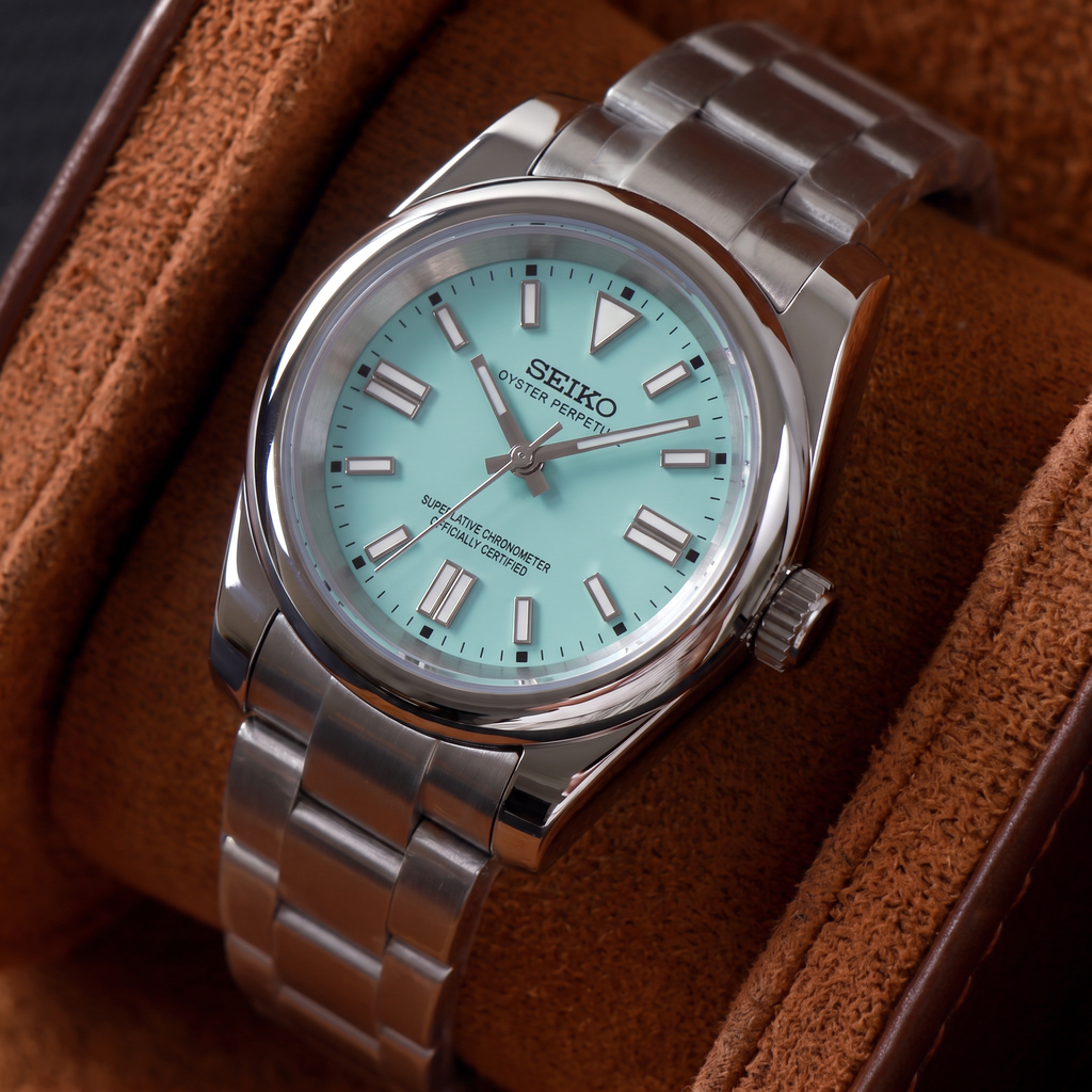 ORA Classic Sport-Style 36mm Seiko Mod watch, aqua dial, smooth polished bezel, steel three-link bracelet – resting in a suede-lined watch box