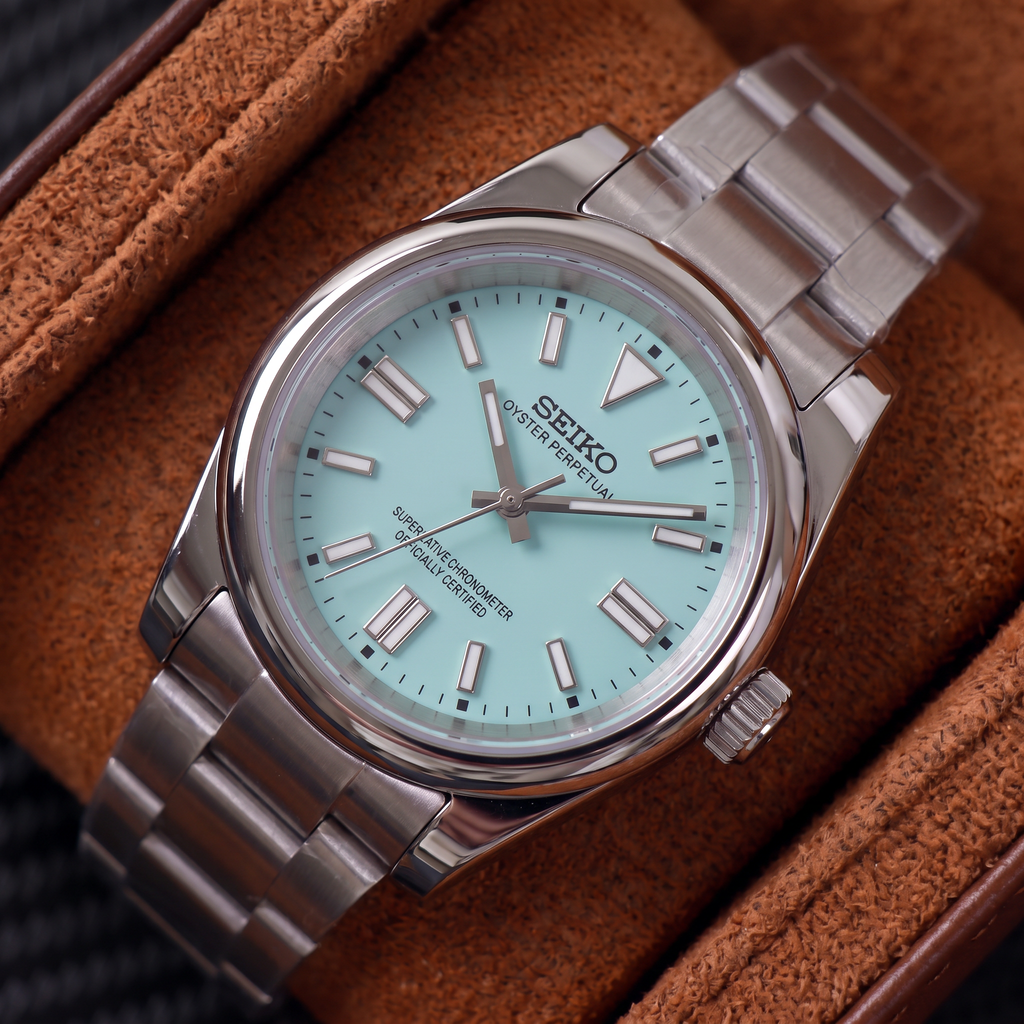 ORA Classic Sport-Style 36mm Seiko Mod watch, aqua dial, smooth polished bezel, steel three-link bracelet – angled view in a suede-lined watch box
